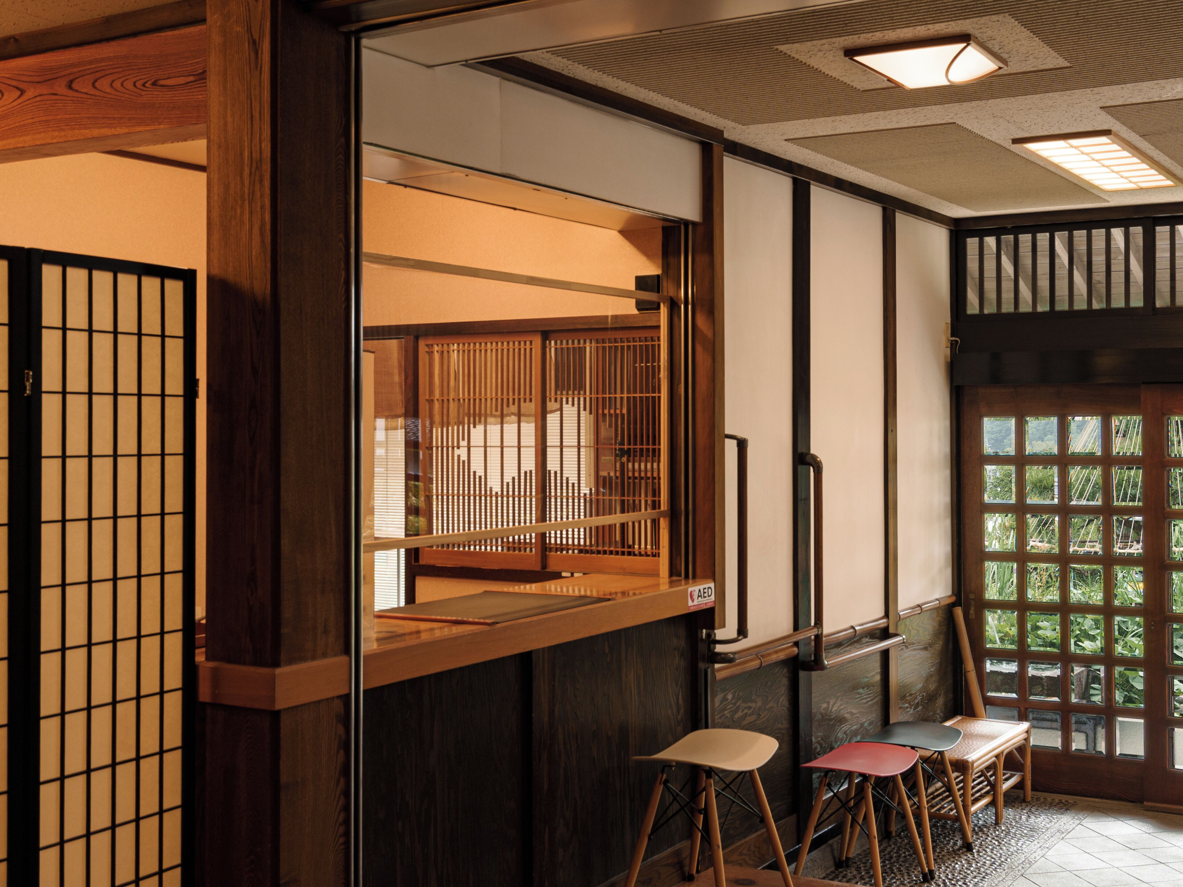 A traditional Japanese interior with tatami flooring, sliding doors, and a low wooden counter.