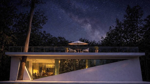 A modern house with a glass facade, a flat roof, and a balcony with outdoor furniture. - 台灣「台東十景」清晨無人的別墅區可眺望湖邊迎接美好假期最重要的一刻 (Chishang Township)