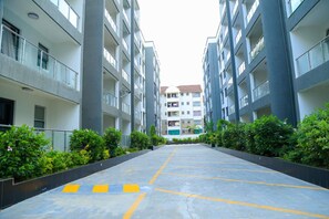 A multi-story residential building with balconies, a central courtyard, and greenery. - Cozy 2bed master-ensuite apt in Nairobi near the Airport and SGR train station (Nairobi)
