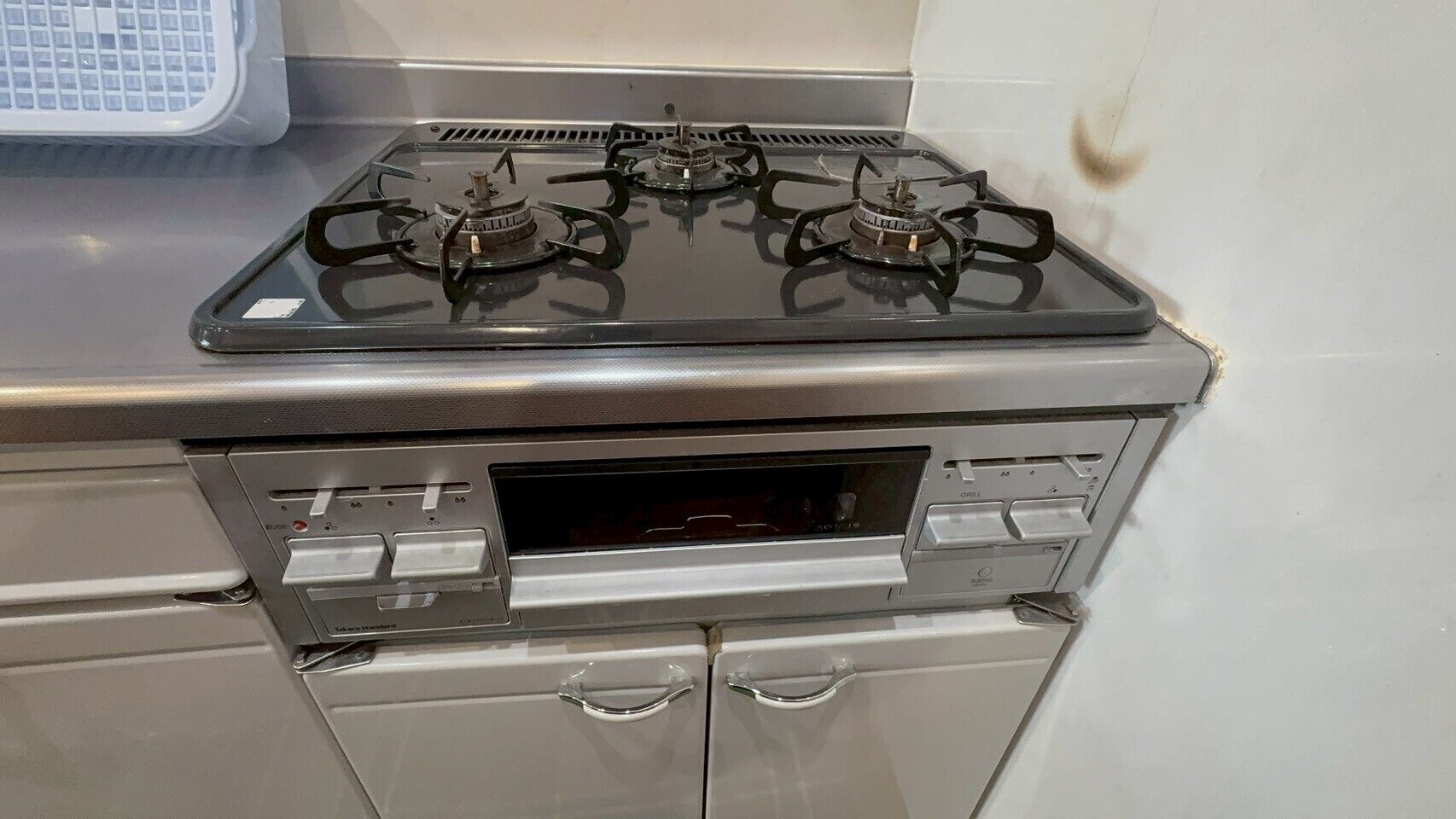 A kitchen with a gas stove, oven, and a microwave.