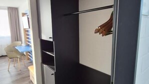 A room with a sliding closet, a desk, and a chair.