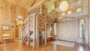 A wooden cabin interior with a staircase, wooden walls, a bench, and a sign reading 'Ski Slopes'. - Hot Tub + Fire Pit: Spacious Waynesville Escape! (Waynesville)