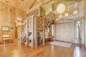 A wooden cabin interior with a staircase, wooden walls, a bench, and a sign reading 'Ski Slopes'. - Hot Tub + Fire Pit: Spacious Waynesville Escape! (Waynesville)