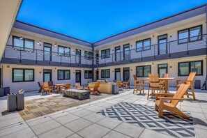 A courtyard with outdoor seating, a pool table, and a bar area. - Long-Term Stay in Denver! Dog-Friendly Studio (Denver)
