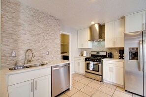 A modern kitchen with a dishwasher, stove, refrigerator, and white cabinets. - Extended Stay w/ Hot Tub! 5 Mi to Old Town ABQ (Albuquerque)