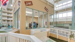 A hotel lobby with a pool area, multiple floors, and a game room. - Pool Access! Family Getaway in Hilton Head Resort (Hilton Head Island)