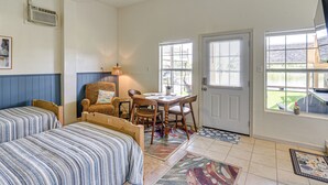 A bedroom with two beds, a desk, and a chair. - Waterfront Studio w/ Dock, 8 Mi to Kemah Boardwalk (Dickinson)