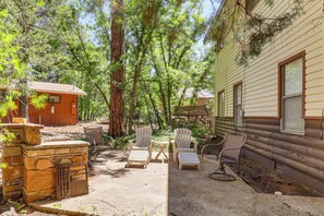 A cabin with a patio area, outdoor seating, and a stone fireplace. - Year-Round Mtn Escape in the 'Arizona Rockies' (Lakeside)