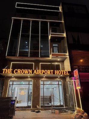 A multi-story building with illuminated signage reading 'The Crown Airport Hotel.' - The Crown Airport Hotel (Ho Chi Minh City)