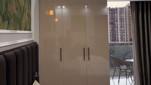 A bedroom with a bed, a wardrobe, a ceiling fan, and a view of a balcony. - The Arlo Northeye 649 | Couple Friendly Stay in central Noida | Self Check-in (Noida)