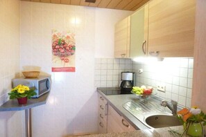 A kitchen with a microwave, coffee maker, and a sink. - Herbert Ziegler Winery "Eulbusch" 2 (Maikammer)