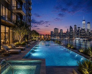 A rooftop infinity pool with a city skyline view, lounge chairs, and a well-lit outdoor area. - Riverson SOHO by Kota Kinabalu (Kota Kinabalu)