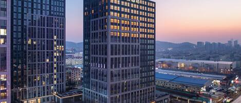 A high-rise hotel with a modern glass facade, multiple floors, and a prominent entrance.