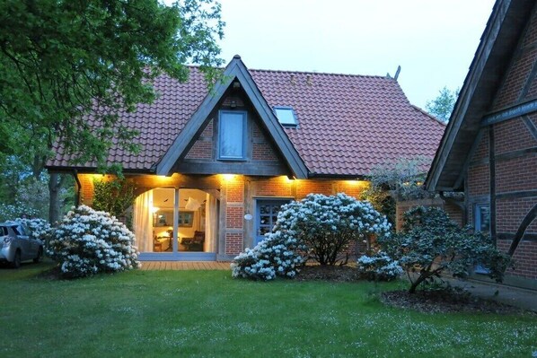 A house with a red-tiled roof, a triangular gable, and a front door with glass panels. - Holiday home in Trebel with swimming pool (Trebel)