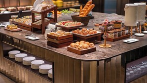 A buffet with various food items, including bread, pastries, and fruits. - Crystal Hotel Qingdao Taidong St. (Qingdao)