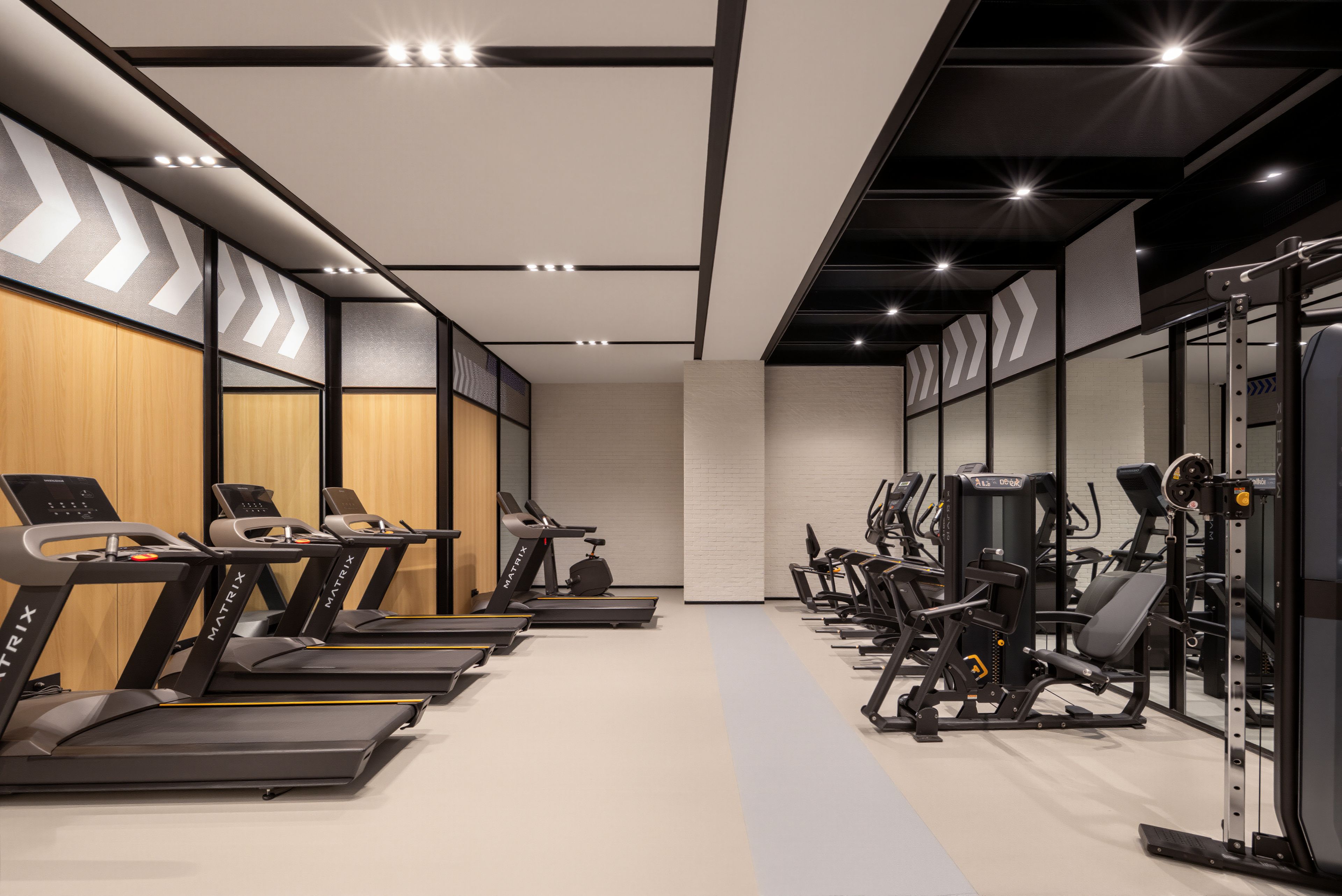 A gym with treadmills, elliptical machines, and weight equipment.