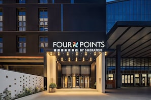 A hotel entrance with a sign reading 'FOUR POINTS BY SHERATON' and a modern building facade in the background. - Four Points by Sheraton Yinchuan Xingqing (Yinchuan)