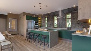 Een moderne keuken met een centraal eiland, barstoelen, een koelkast en een accentmuur van steen.