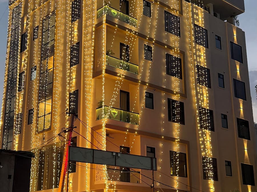 A multi-story building with a sign reading 'Hotel Vinayak Vista.'