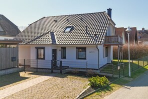 A single-story house with a tiled roof, a front porch, and a small garden area. - House Clemens in the Baltic seaside resort of Thiessow (Thiessow)