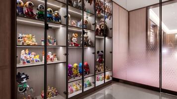 A large display of various plush toys and figurines in a well-lit room with a polished floor.