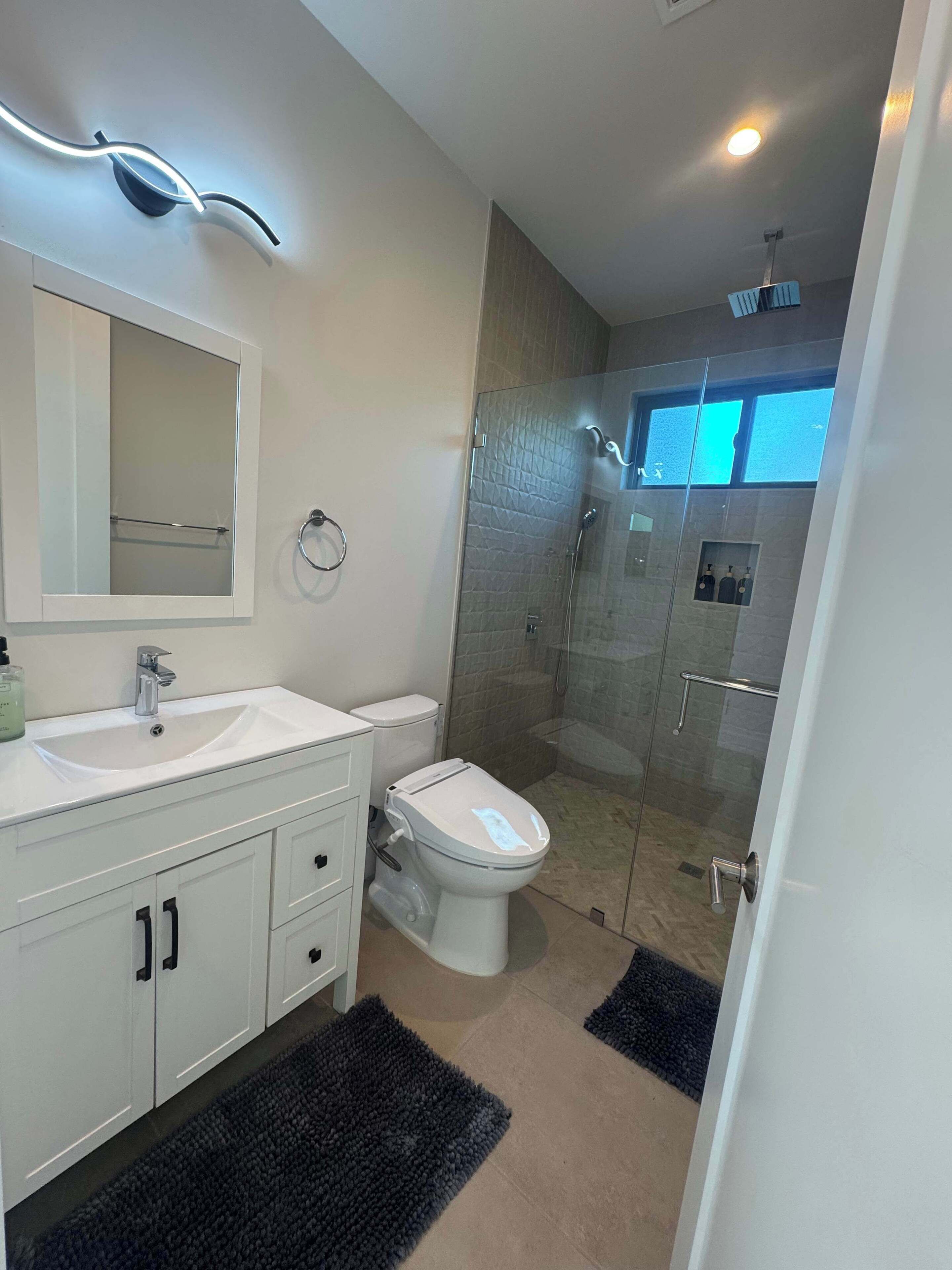Shower, hair dryer, towels, shampoo