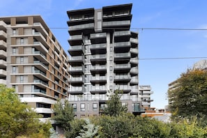 A multi-story residential building with balconies, a central stairwell, and a clear sky. - Modern Living in the Heart of Hawthorn East (Melbourne)