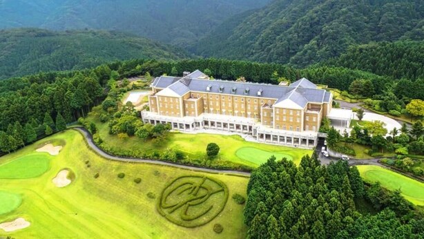 Un hotel grande de varios pisos con un campo de golf al frente.