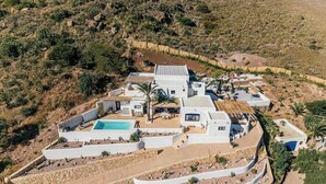 A white villa with a swimming pool, multiple rooms, and a landscaped garden. - Mediterranean-style house in Cabo de Gata (Almeria)