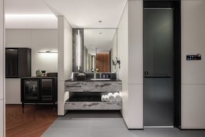 A modern kitchen with a marble countertop, built-in oven, and a black refrigerator. - Intercity Hotel Qingdao Sino-Euro Sea (Qingdao)