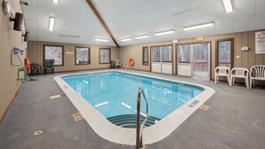 A swimming pool with a lifeguard chair, a hot tub, and a view of the outdoors. - Townhome Near Gore Mtn | Covered Heated Pool + Rec Lounge | Quick Silver (North Creek)