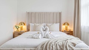 A hotel room with a large bed, two bedside tables with lamps, and a window with curtains. - MAGICAL MARBLE 3 BEDROOM KNIGHTSBRIDGE GOLDEN APARTMENT WITH BALCONY (Greater London)
