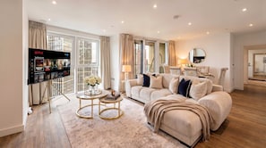 A modern living room with a sofa, coffee table, and TV displaying Netflix content. - INSTAGRAM VIRAL SKY HIGH SANCTUARY With Gym and Exclusive Rooftop, Floor to Ceiling Windows (London)
