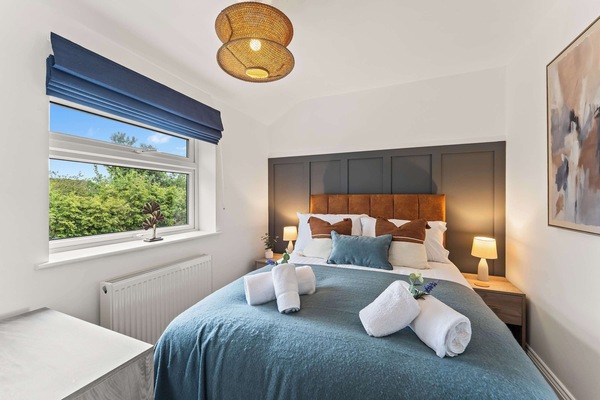 Bedroom 2 features a double bed, with a chest of drawers for you to unpack your belongings, a full length mirror and bedside tables.