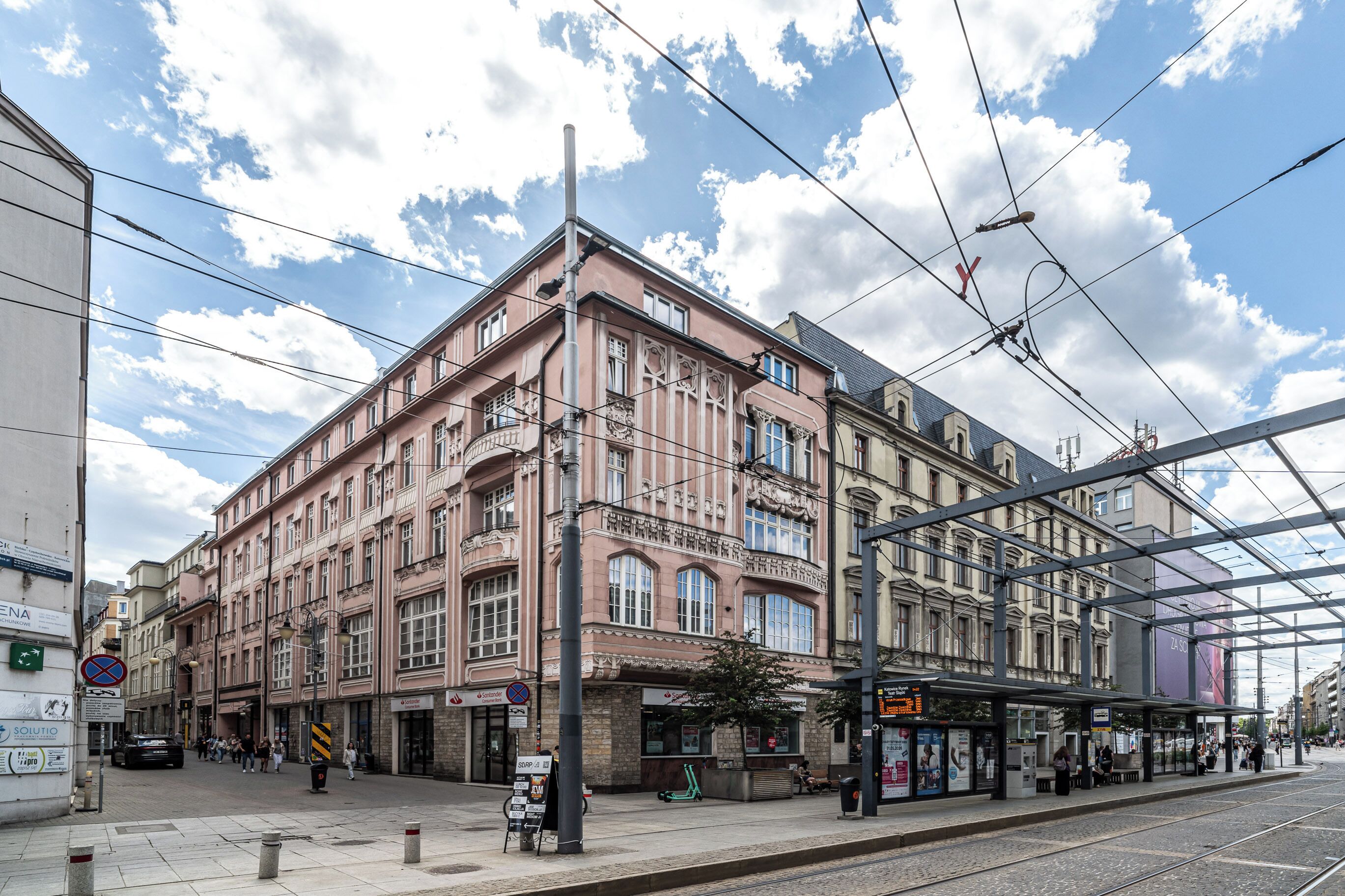 A multi-story building with a classic architectural style, featuring large windows and a balcony.