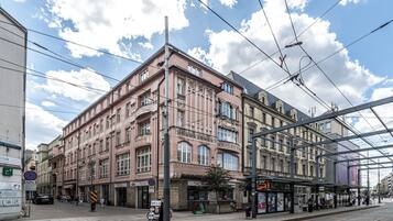 A multi-story building with a classic architectural style, featuring large windows and a balcony.