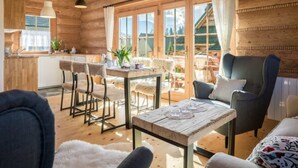 A wooden interior with a dining area, chairs, a table, and a view of the outside. - Holiday Villa With Mountain Views, Koscielisko (Koscielisko)