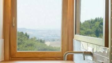 Deluxe Quadruple Room, Garden View | Bathroom | Shower, free toiletries, hair dryer, towels
