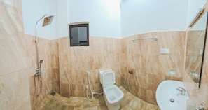 A bathroom with a shower, toilet, and sink, all with marble walls and a small window. - Nilaro Holiday Resort (Anuradhapura)