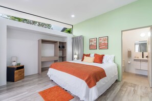 A modern bedroom with a bed, a wardrobe, a desk, and a bathroom. - Side by Side Villas Walking Distance to Both Playa Tamarindo & Playa Langosta (Playa Langosta)