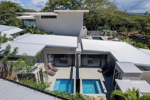 A modern house with a swimming pool, a covered patio, and a view of the surrounding greenery. - Brand New 3 Bedroom Villa, Walking Distance to Tamarindo and Langosta (Playa Langosta)