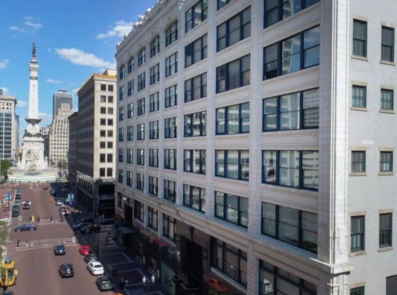 A multi-story building with a modern architectural style, featuring a grid of windows and a flat facade.
