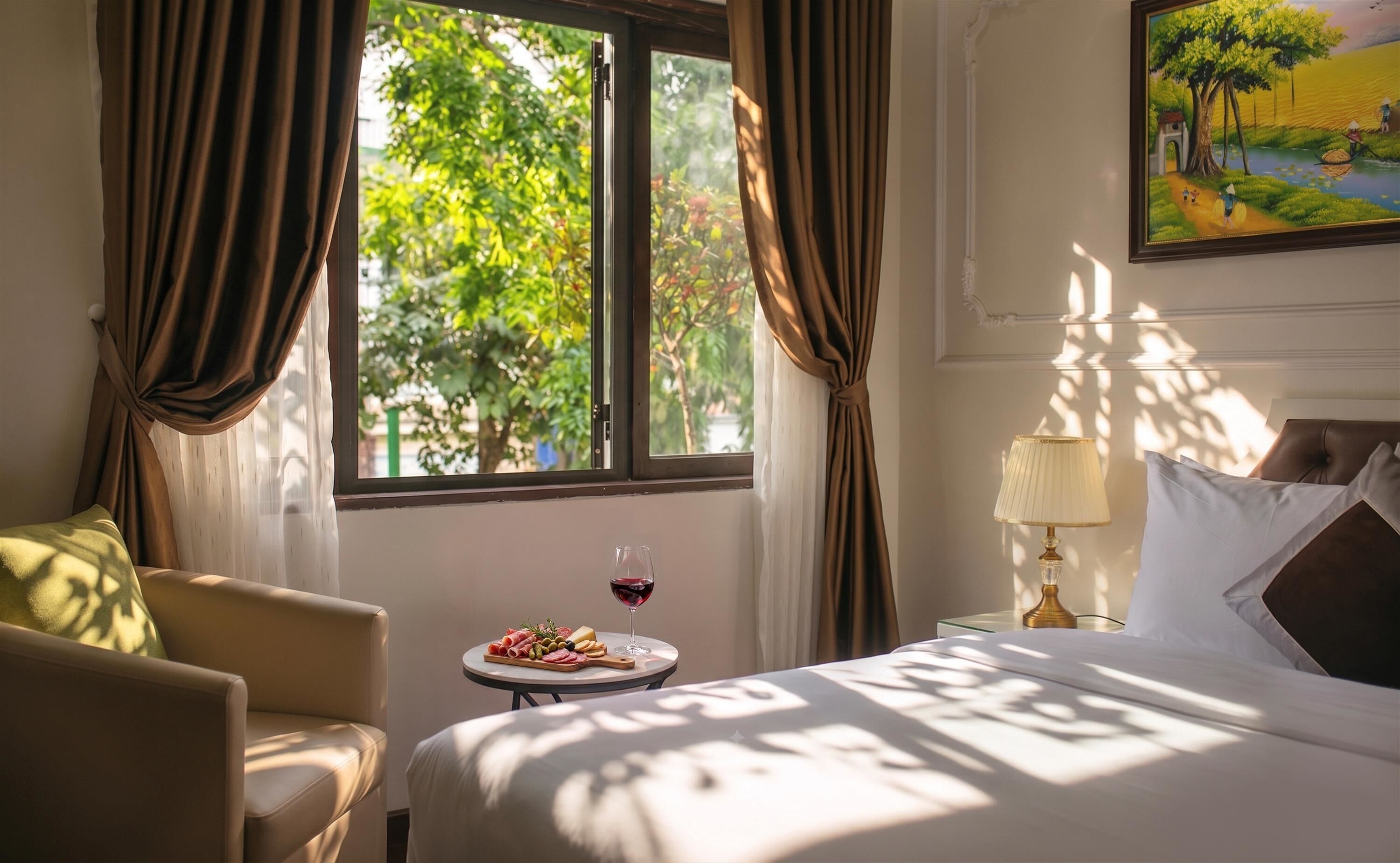 A hotel room with a bed, a small table with food and drink, a lamp, and a painting on the wall.