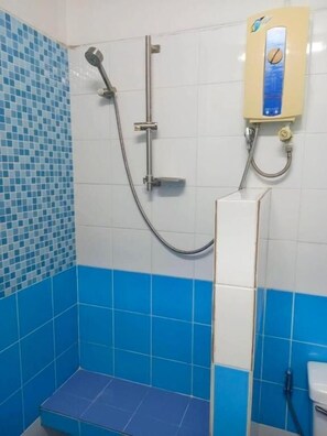 A bathroom with a shower, a toilet, and a wall-mounted heater. - Bella B Plus Hotel (Bangkok)