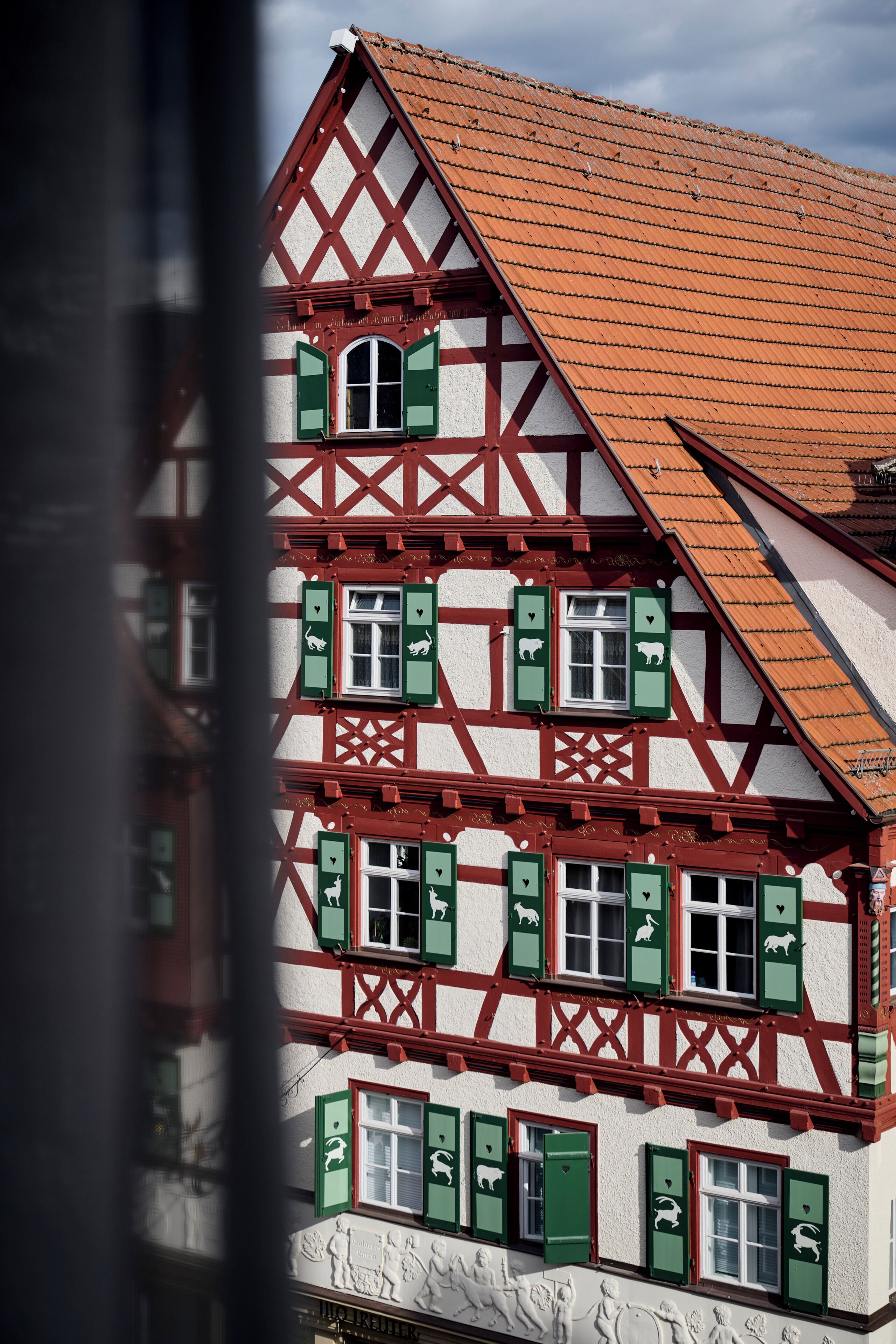A traditional half-timbered building with multiple windows and a steeply pitched roof.