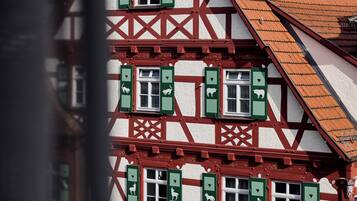 A traditional half-timbered building with multiple windows and a steeply pitched roof.