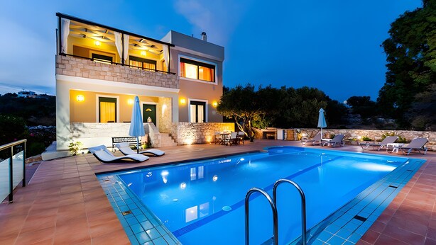 A modern two-story house with a swimming pool, outdoor furniture, and a stone wall. - Villa Renata with Private Pool, Mountain View, Wi-Fi and Air Conditioning (Aptera)