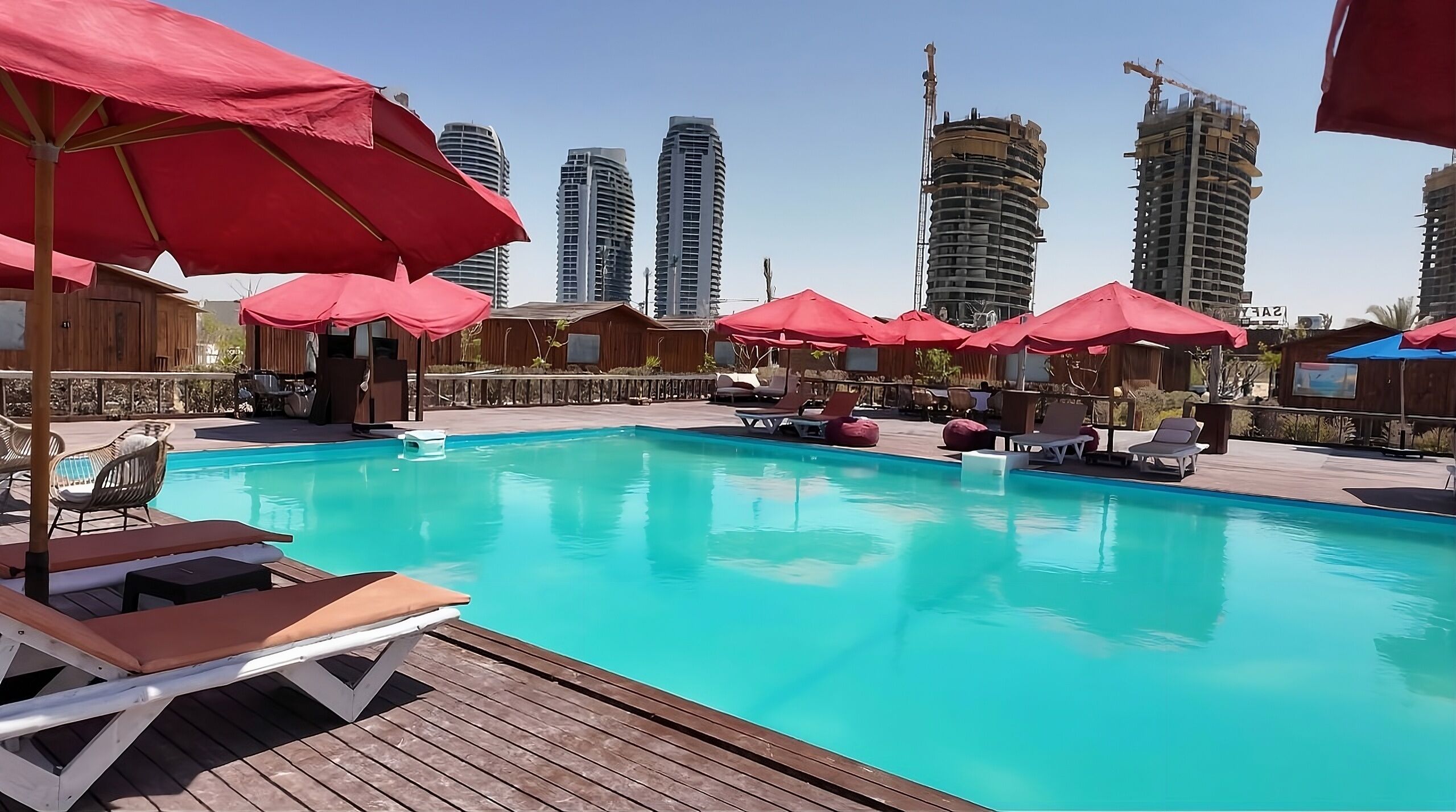 Seasonal outdoor pool, open 10:00 AM to 7:00 PM, pool umbrellas