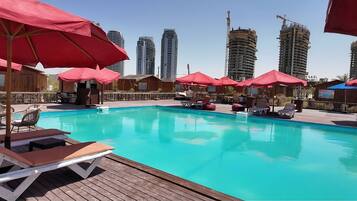 Seasonal outdoor pool, open 10:00 AM to 7:00 PM, pool umbrellas