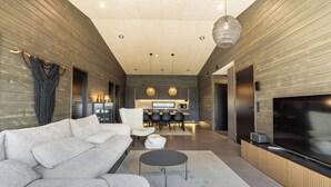 A modern living room with a sofa, a coffee table, and a TV. - Villa Noel B (Lappi)